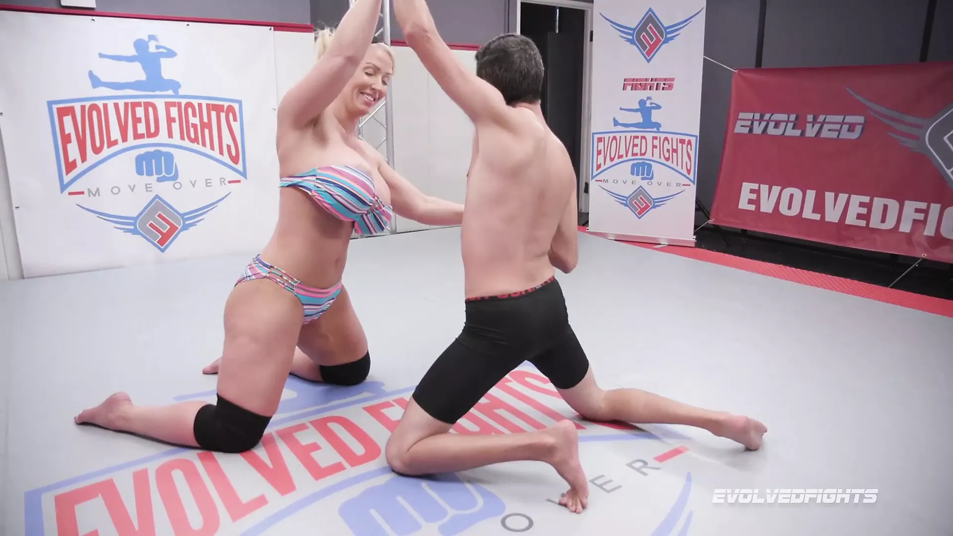 Alura Jenson kicks opponent in balls in nude wrestling image
