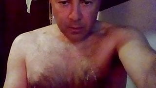 Daddy masturbating, filling his mouth with milk.