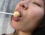 three cute Japanese gals licking lollypops