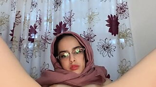 Arab with hijab on stretches using anal toys