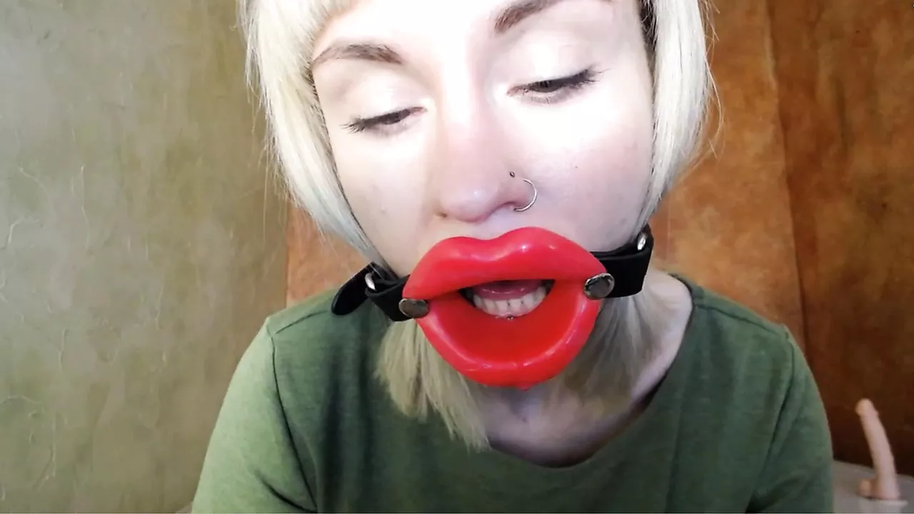 Zooming in red lips open mouth gag for dildo-blowjob
