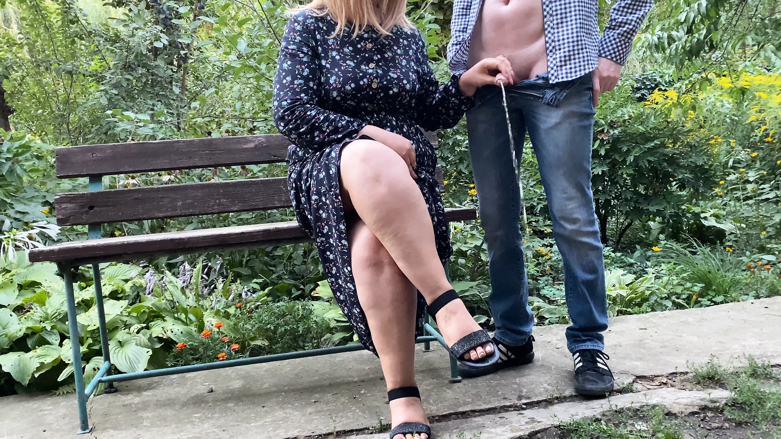 SHE holds his cock while HE pee in the park photo
