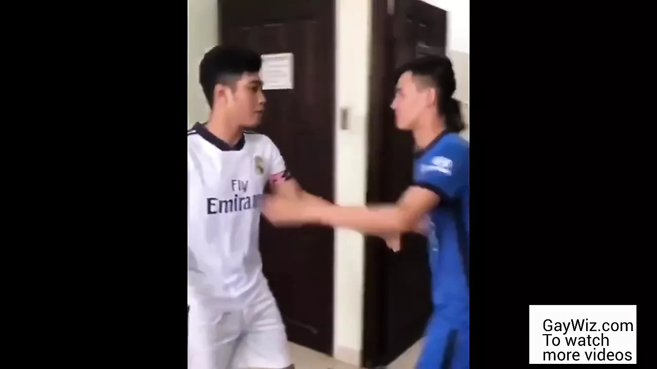 Two Asians wearing soccer uniform have picture