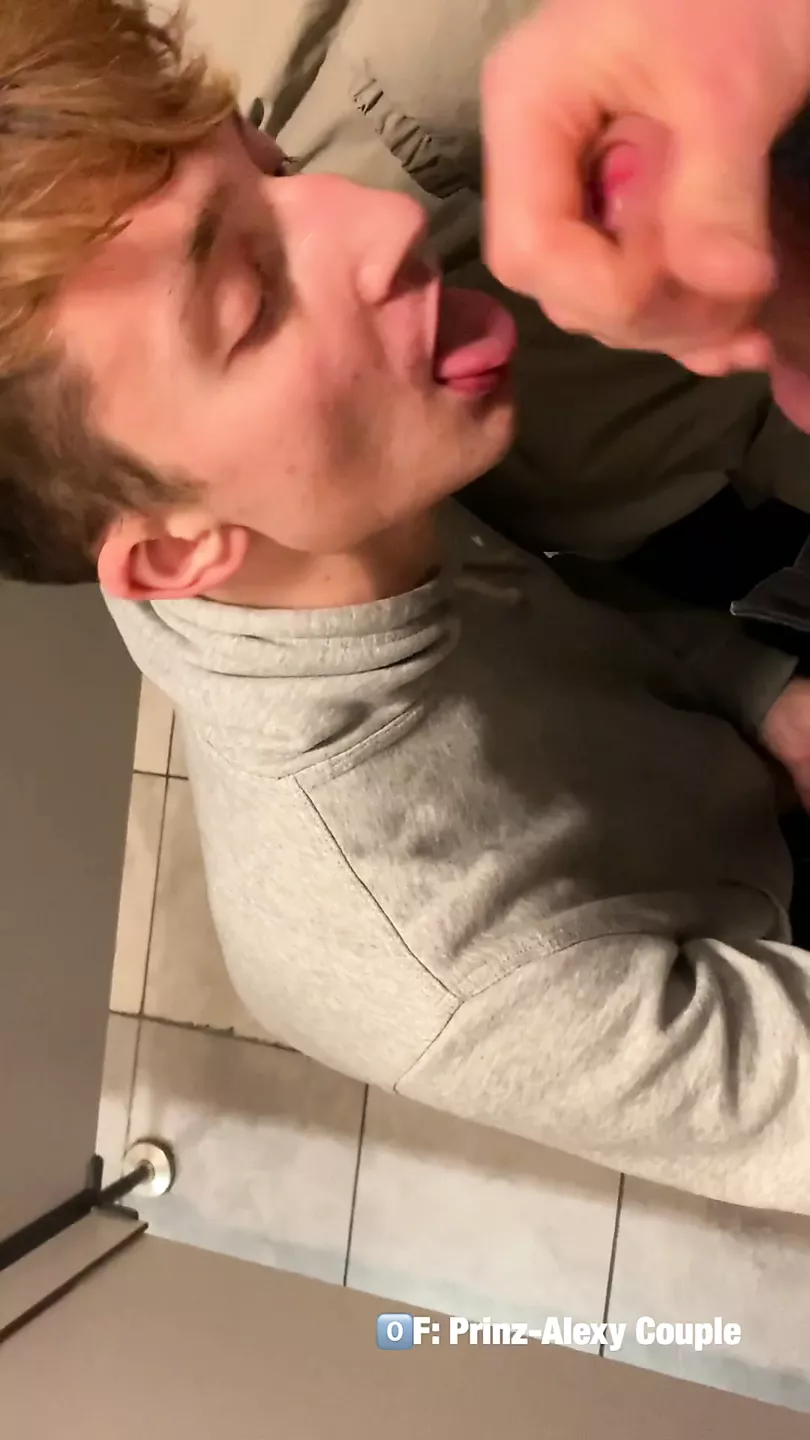 Twink gives a blowjob random guy in the public Restroom and takes cumshot on his face photo