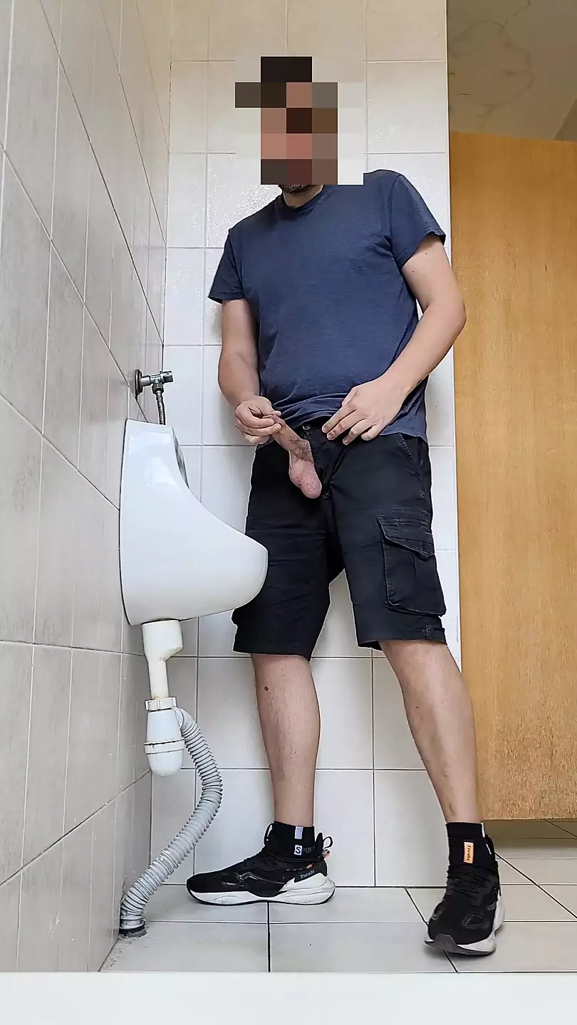 Risky wank in public urinal pic