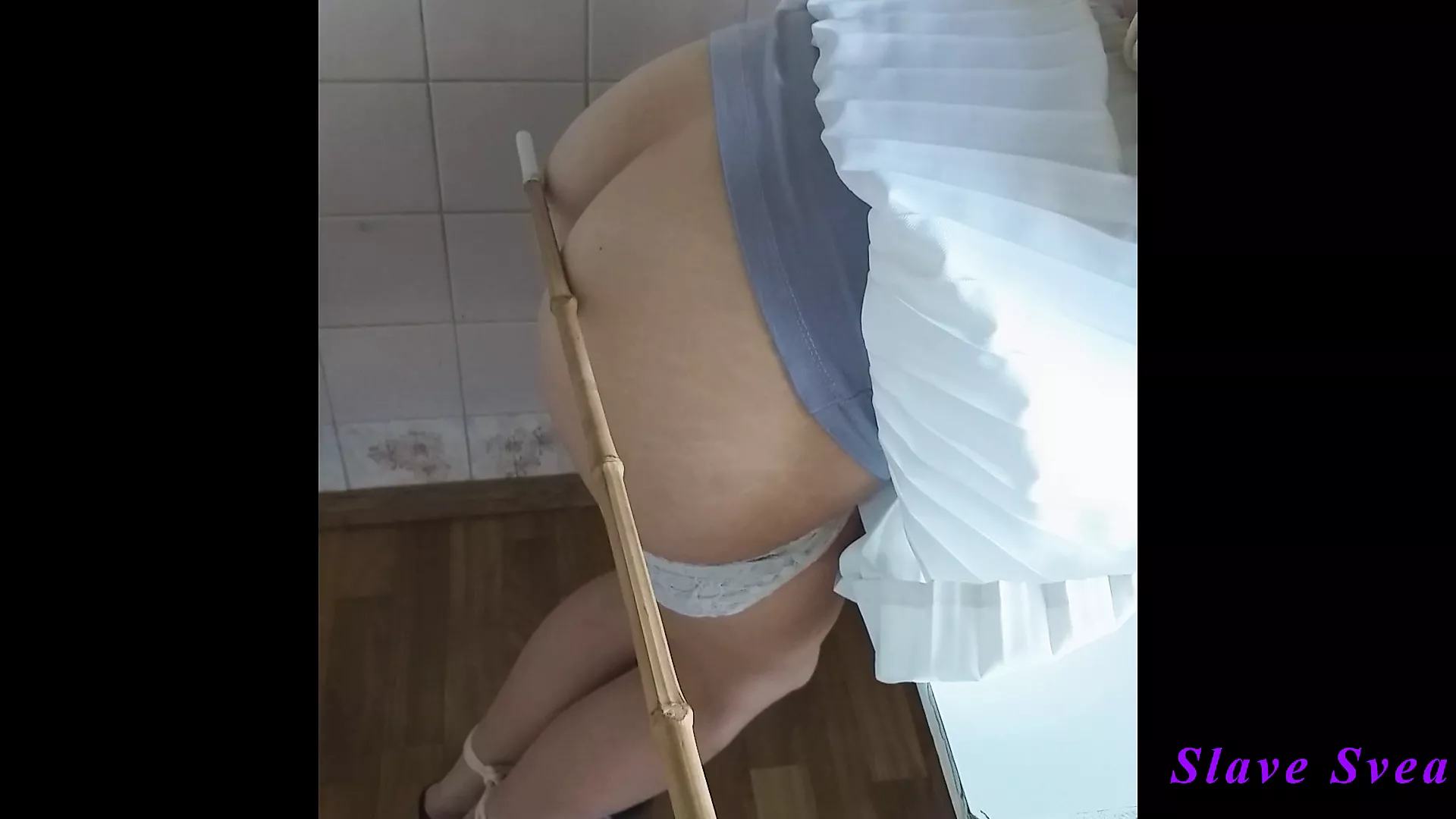 Spanking bare butt with bamboo picture