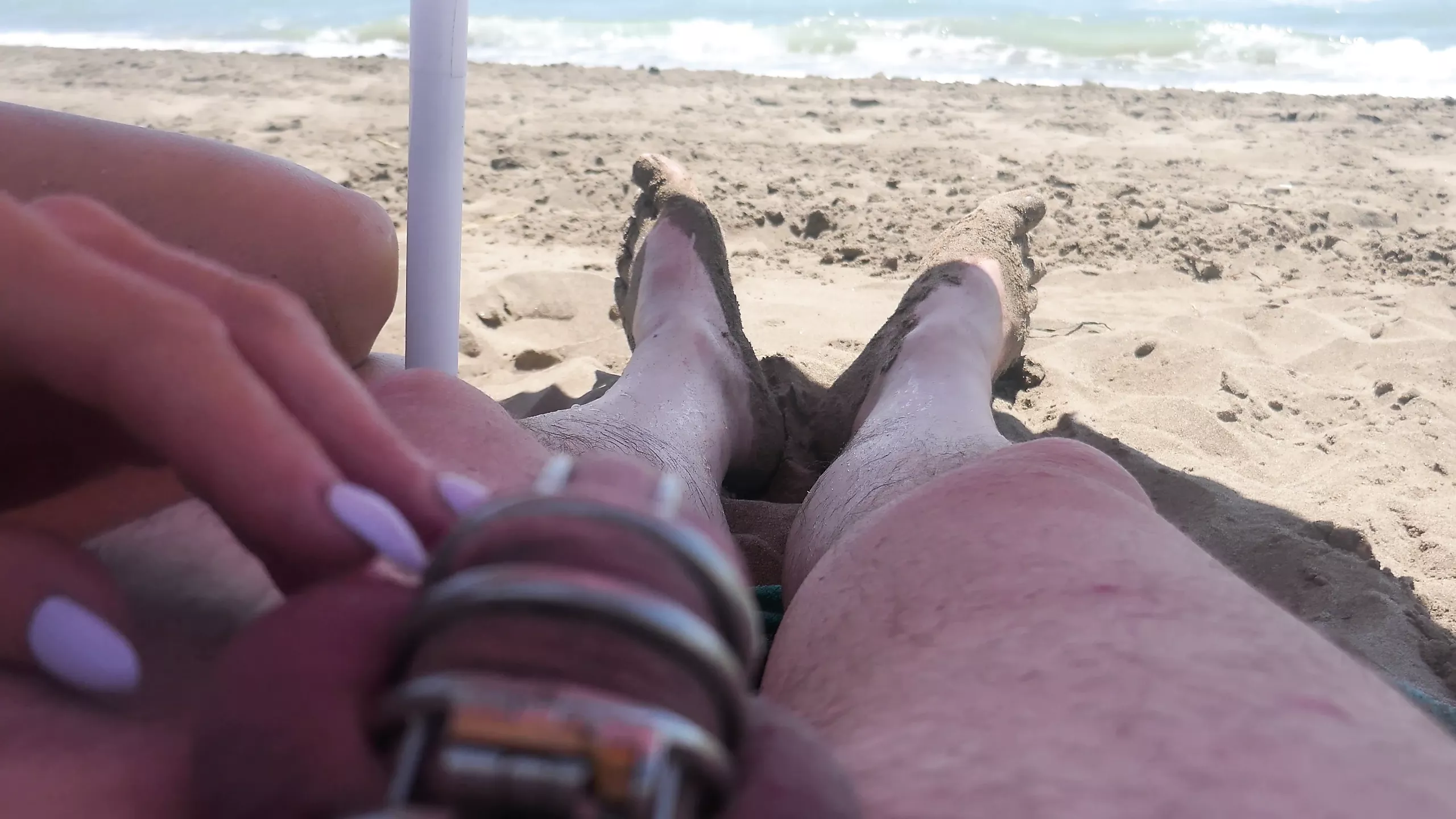 teasing in chastity on the beach pic