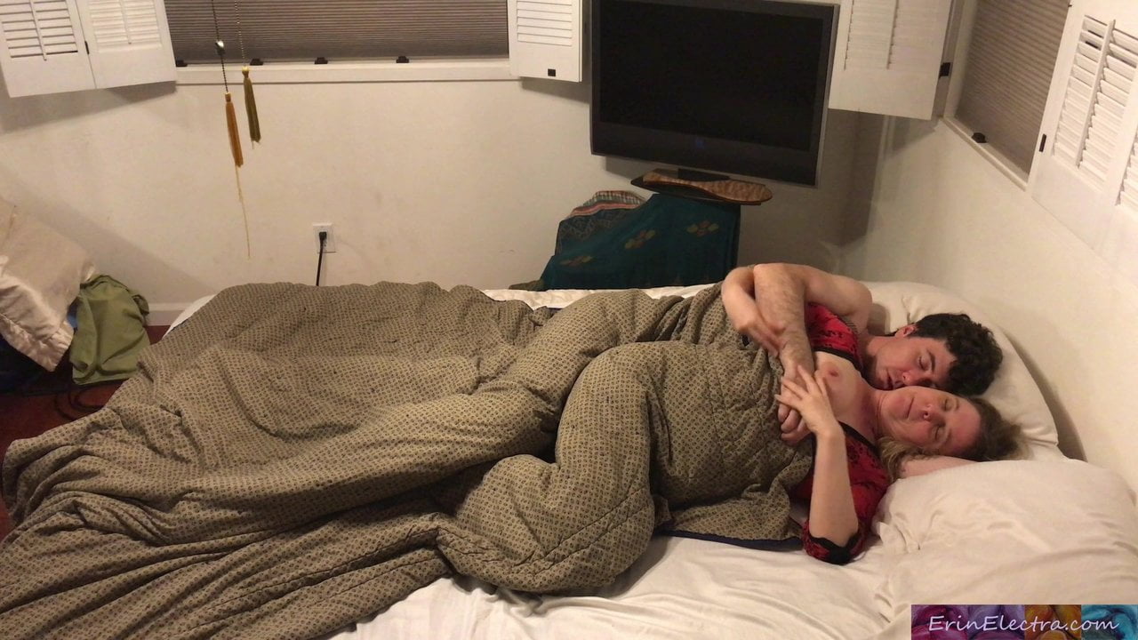 Stepmom shares bed with stepson. 