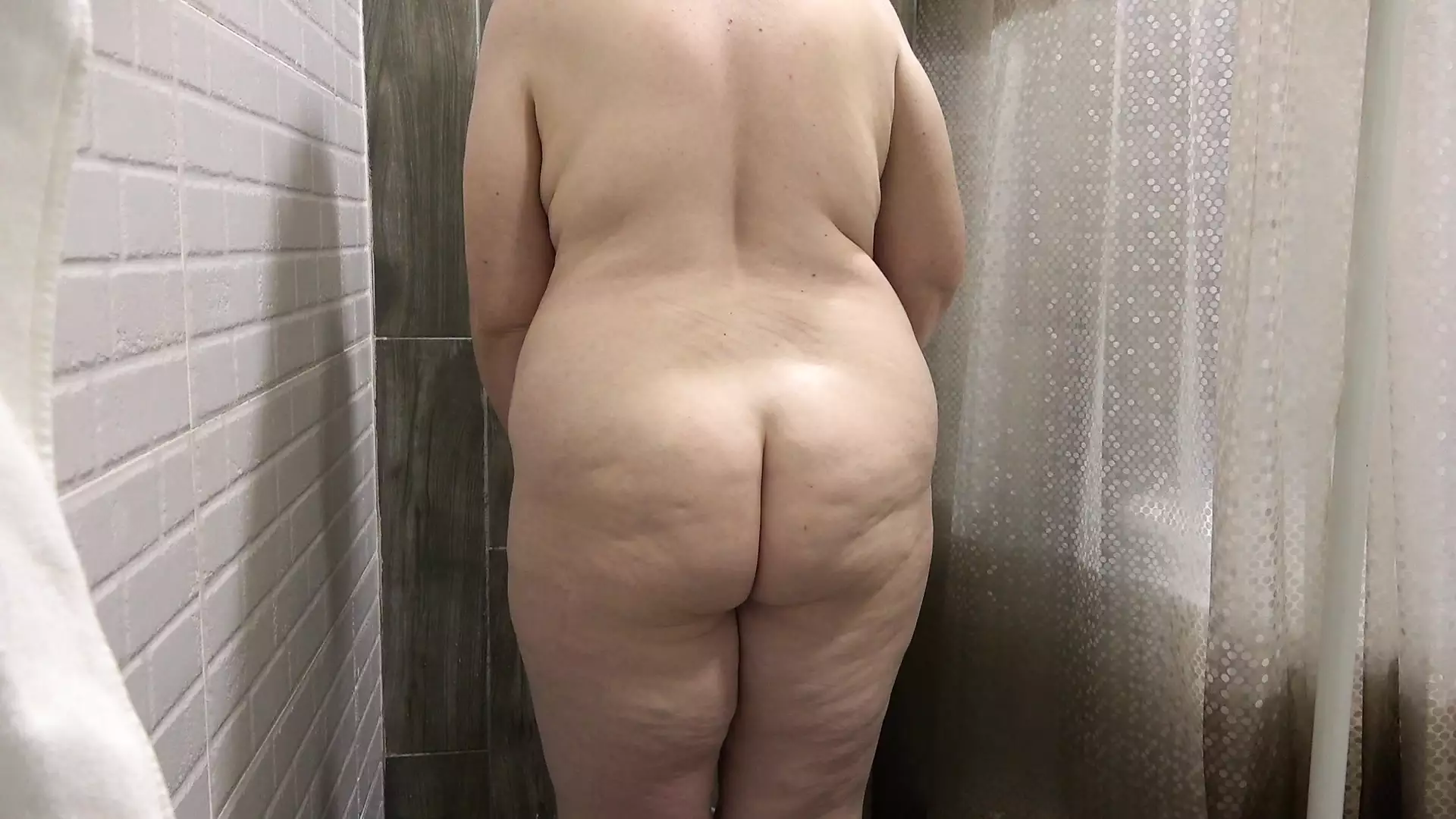 The camera in the shower is watching a curvy MILF. Mature bbw washes fat ass, big boobs, hairy pussy. PAWG. Amateur fetish